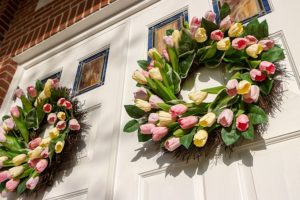 a spring wreath on the front door sets the stage